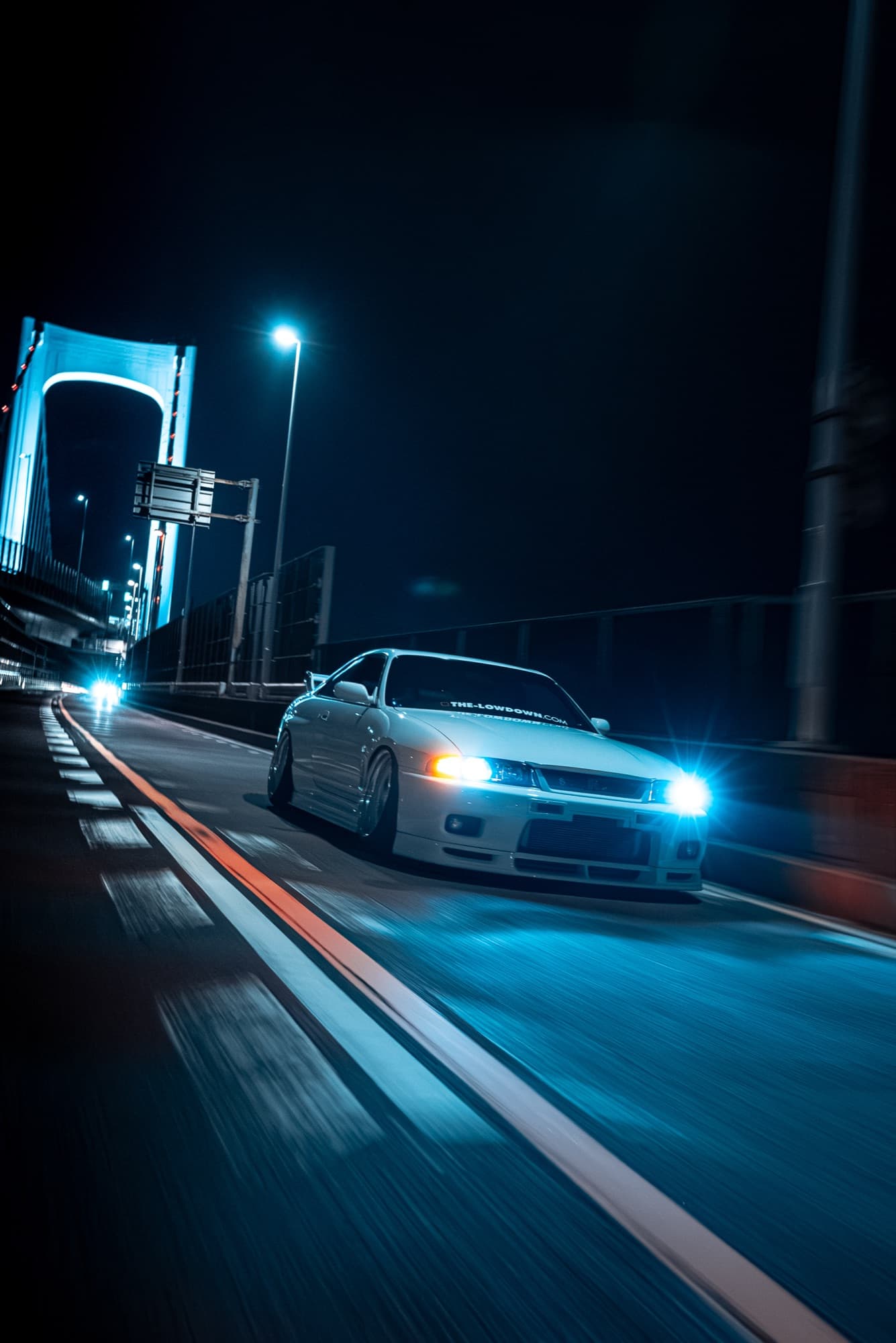 Nissan Skyline GT-R — night rolling shot under bridge lights