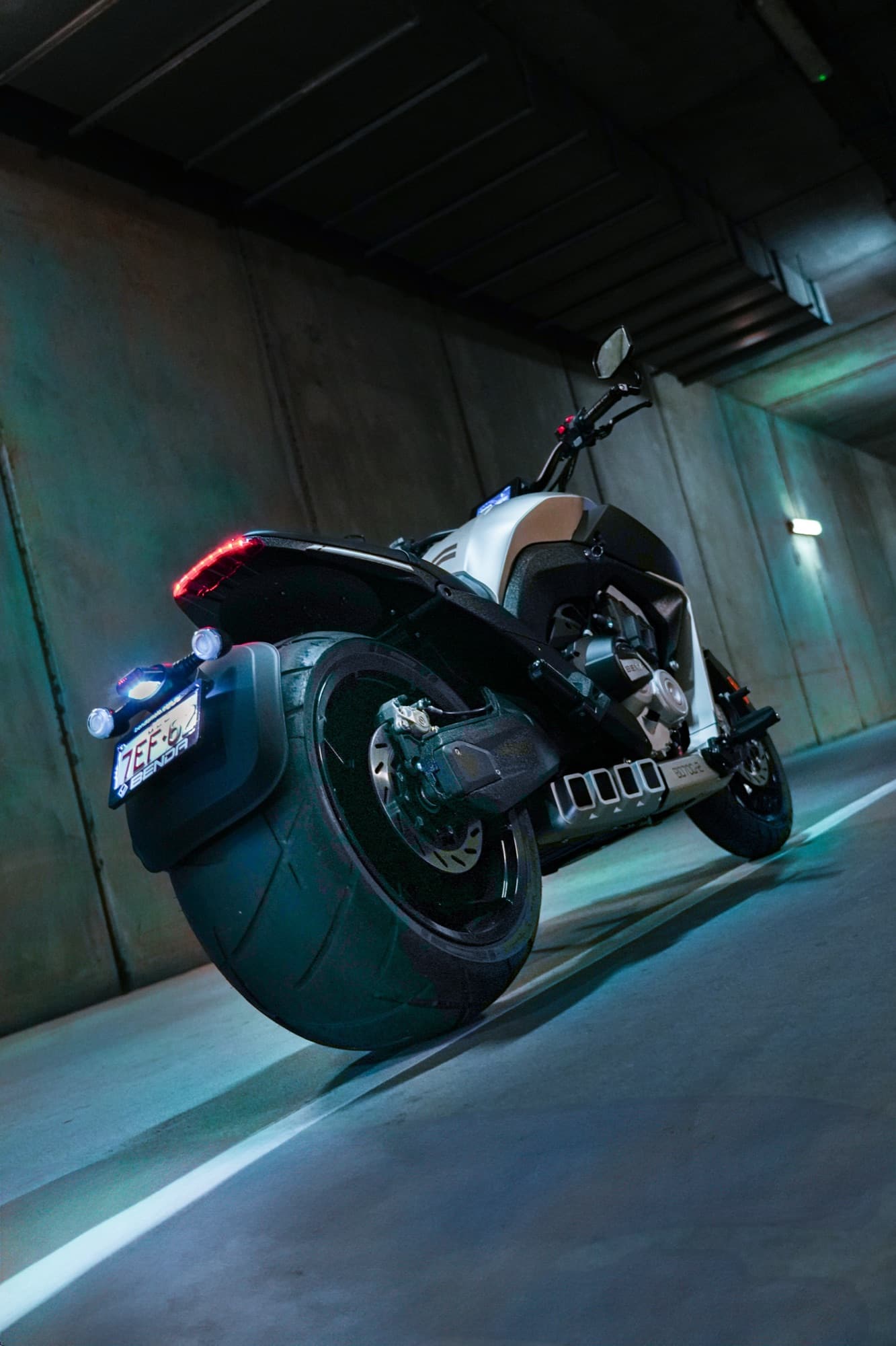 Custom motorcycle — low rear angle in a concrete underpass