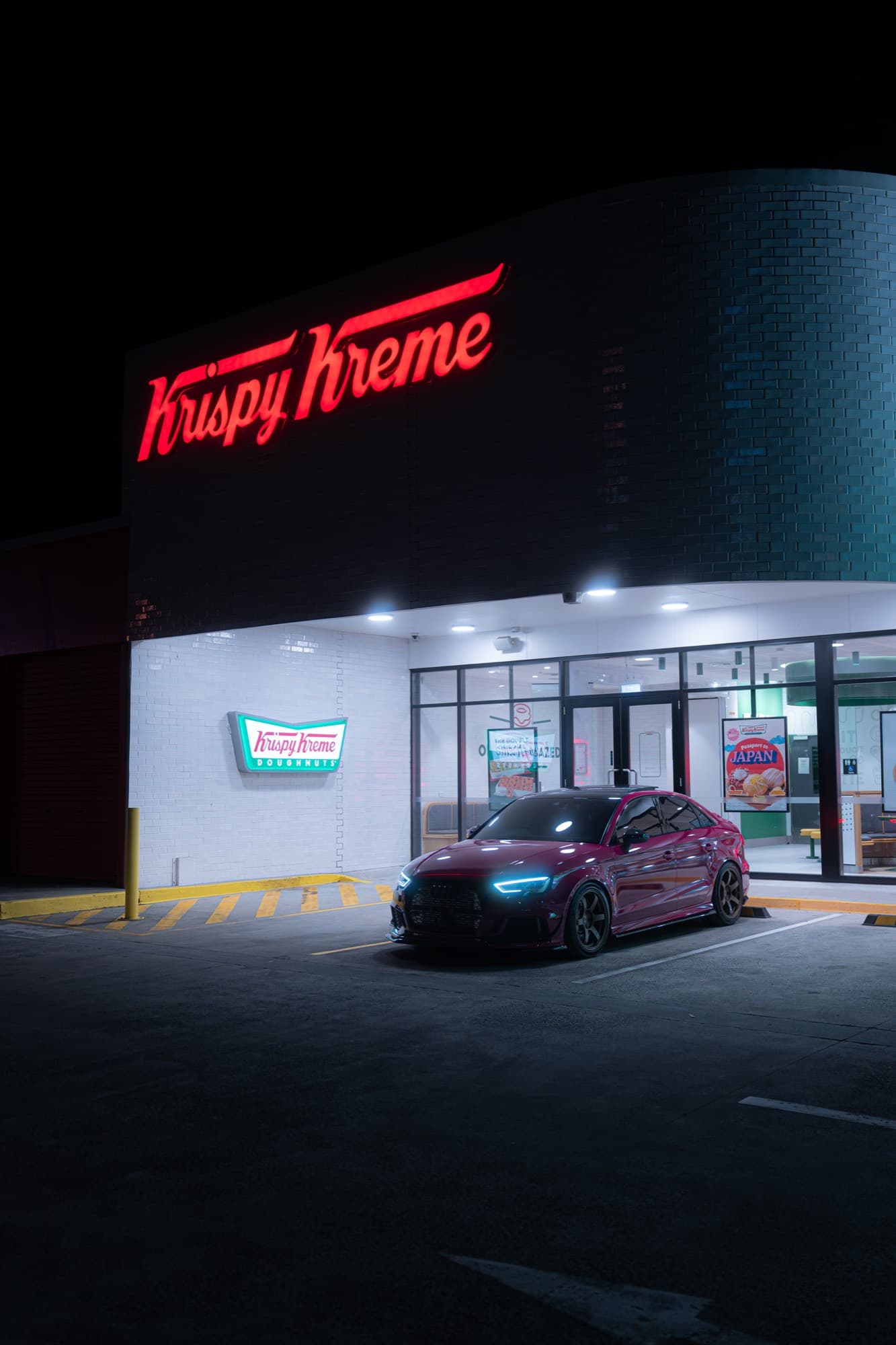 Audi RS3 — neon storefront at night